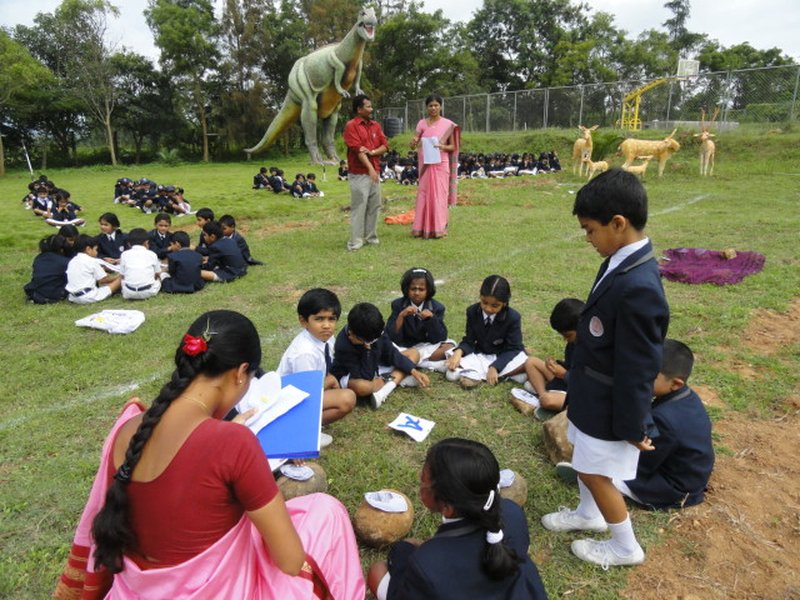 Children as team are trying to create stories on stones